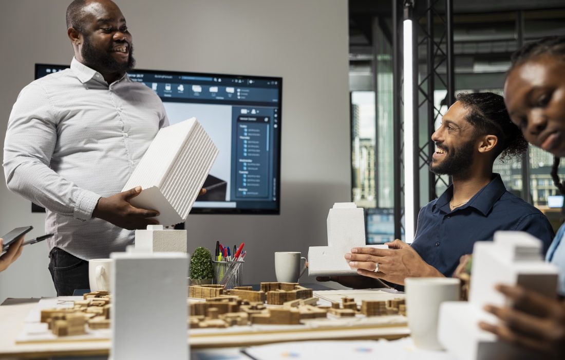 Diverse team of developers sharing construction details in a briefing session, urban development vision using advanced architectural software and 3D models for a modern housing project.